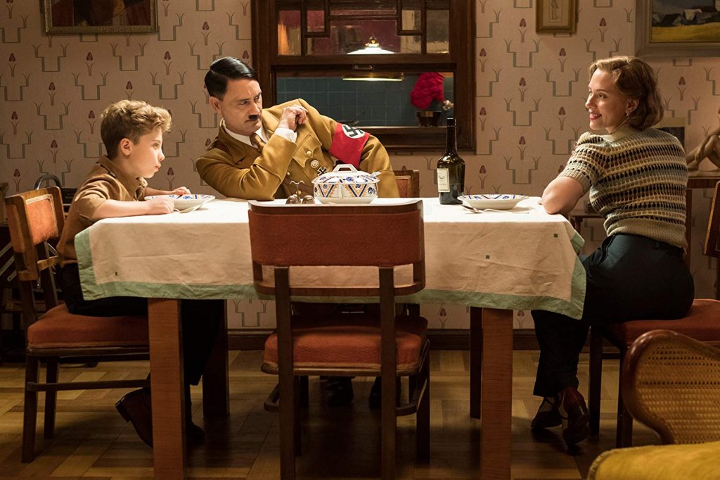 Roman Griffin Davis (left-right), Taika Waititi, and Scarlett Johansson in Jojo Rabbit.