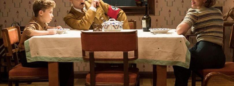 Roman Griffin Davis (left-right), Taika Waititi, and Scarlett Johansson in Jojo Rabbit.