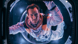 Astronaut Brian Harper (Patrick Wilson) peering into space inside the Space Shuttle in the sci-fi epic MOONFALL