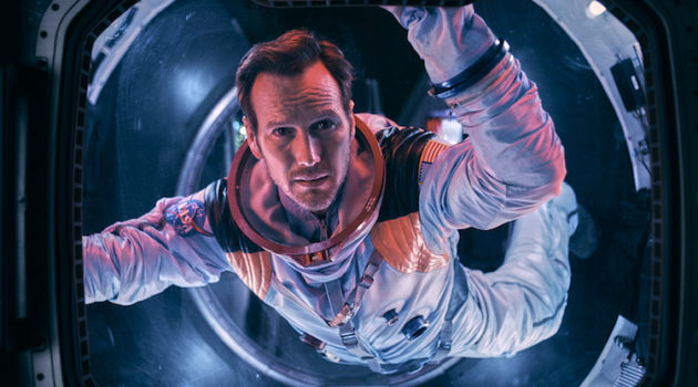 Astronaut Brian Harper (Patrick Wilson) peering into space inside the Space Shuttle in the sci-fi epic MOONFALL