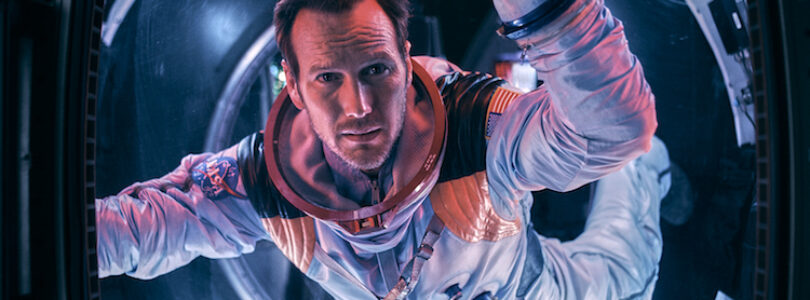 Astronaut Brian Harper (Patrick Wilson) peering into space inside the Space Shuttle in the sci-fi epic MOONFALL