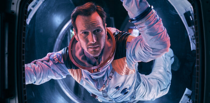 Astronaut Brian Harper (Patrick Wilson) peering into space inside the Space Shuttle in the sci-fi epic MOONFALL