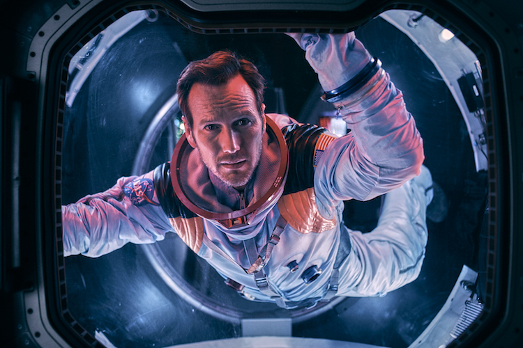 Astronaut Brian Harper (Patrick Wilson) peering into space inside the Space Shuttle in the sci-fi epic MOONFALL